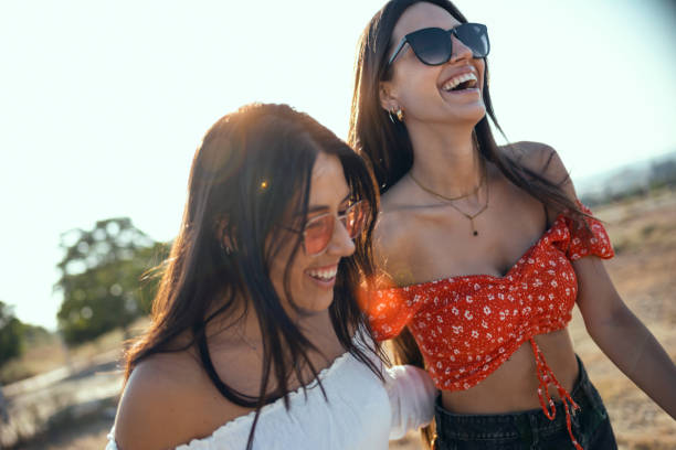 istock Two smiling young women talking anad laughing while enjoying summer on road trip. 1330105401