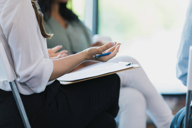 istock Unrecognizable female group leader gestures as she speaks 1330107339