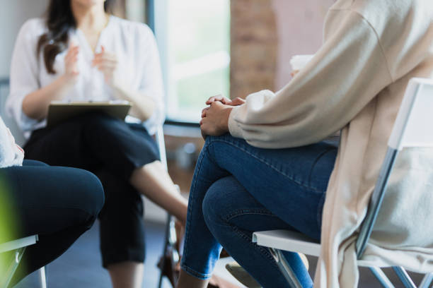 istock Low angle view unrecognizable women listening to unrecognizable therapist 1330107348