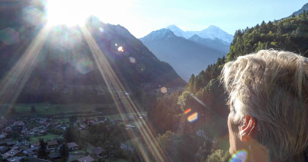 istock Man hikes along sunny mountain ridge in the morning 1330107467