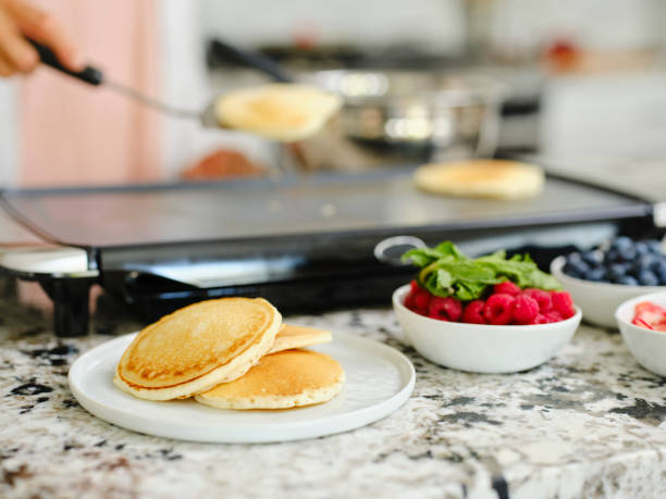 istock Woman Cooking Pancake Breakfast in a Home Kitchen 1330109068