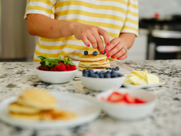istock Woman Cooking Pancake Breakfast in a Home Kitchen 1330109094