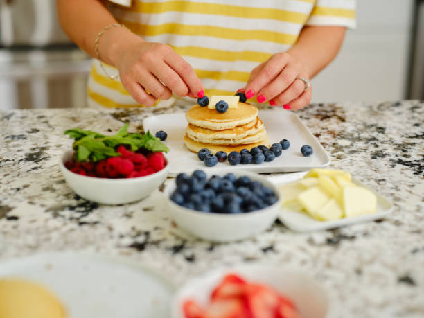 istock Woman Cooking Pancake Breakfast in a Home Kitchen 1330109095