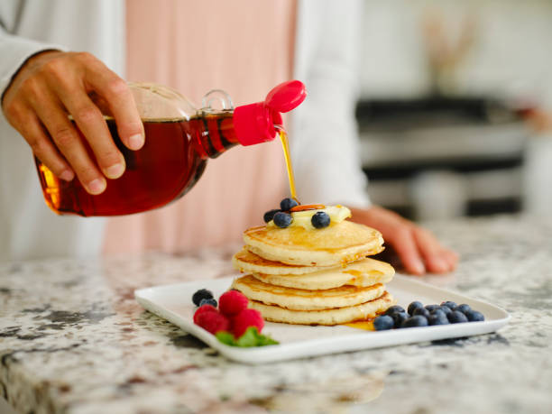 istock Woman Cooking Pancake Breakfast in a Home Kitchen 1330109156