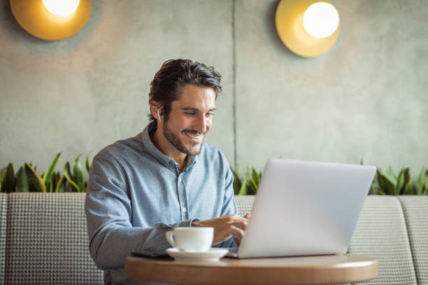 istock Man working on laptop at cafe 1330112456