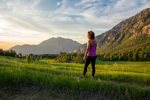 A woman enjoys a summer afternoon and evening running on a trail in the mountains above Provo, Utah.