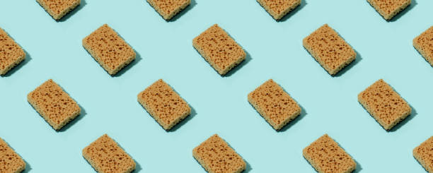 istock Seamless Pattern with neutral beige clean sponges for home cleaning on blue background. Banner for your site, concept for laundry, cleaning service, advertising, spring regular cleaning day 1330115963
