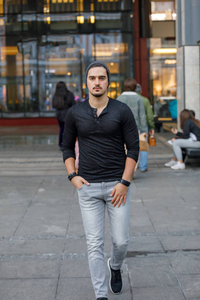 istock Young Man is Walking Down the City Streets. 1330118425