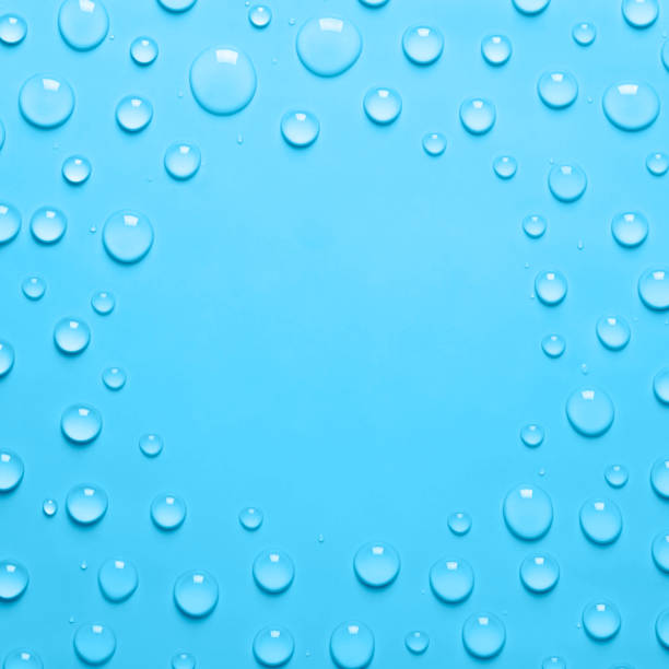 istock Square Frame of Water drops on a pastel blue background. Water texture close up. Backdrop glass covered with drops of water. Water bubbles 1330119686