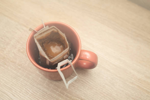 istock Coffee Drips in cup. Alternative brewing coffee in paper filter bags. 1330120339