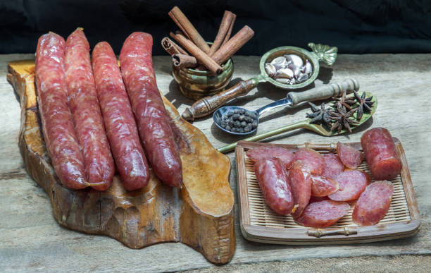 istock Dried Chinese sausage with herb on old wooden table. 1330120992
