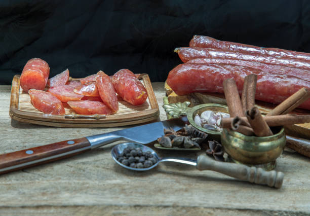 istock Dried Chinese sausage with herb on old wooden table. 1330120998