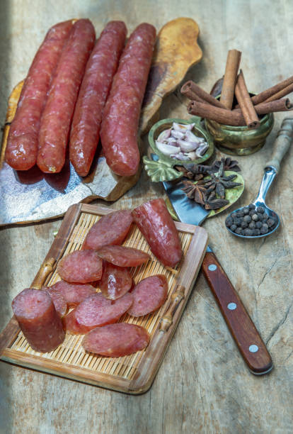 istock Dried Chinese sausage with herb on old wooden table. 1330121002