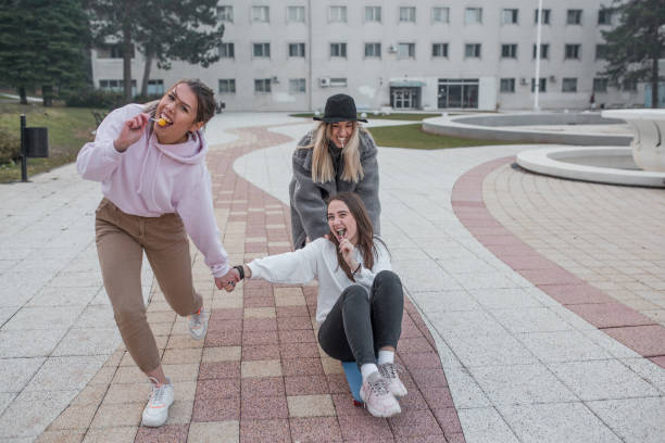 istock Friends having fun in the park on cold autumn day 1330121943