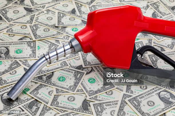 Gasoline Fuel Nozzle And Cash Money Gas Price Tax Ethanol And Fossil Fuel Concept Stock Photo - Download Image Now