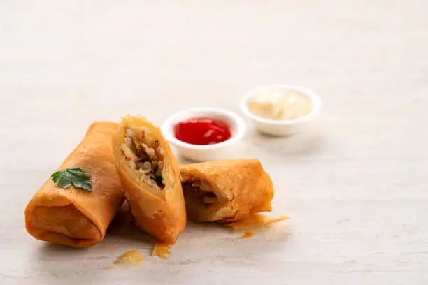 Close Up Deep Fried Spring Rolls, Popular as Lumpia (rebung) or Popia. Served on Stone Table, SIolated with Copy Space for Text