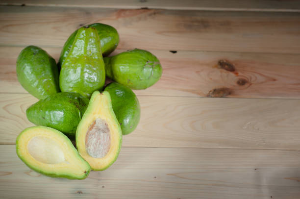 istock fresh avocado fruit and sliced ​​avocado on wooden table 1330127583