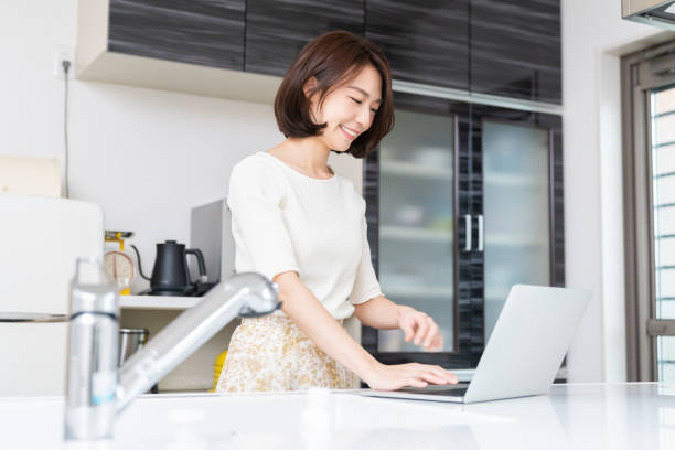 istock young asian woman using laptop 1330130829
