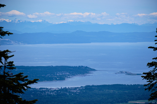 Looking down on Courtenay and Comox from Forbidden Plateau on Vancouver Island, BC.  Across the Georgia Strait lies Texada Island and the snow-covered peaks of the BC mainland.