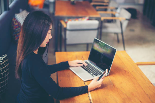 istock Happy freelance woman is relaxing on comfortable couch and using laptop at home.communicates on Internet with customer. 1330134259