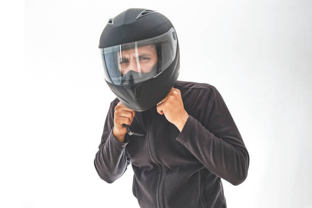 istock Man with a motorcycle helmet giving a thumbs up gesture. Isolated on white studio wall. 1330136075
