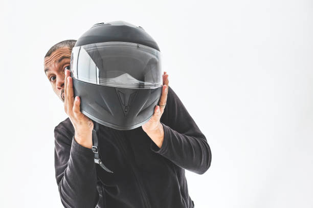 istock Man with a motorcycle helmet giving a thumbs up gesture. Isolated on white studio wall. 1330136085