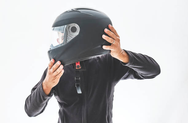 istock Man with a motorcycle helmet giving a thumbs up gesture. Isolated on white studio wall. 1330136087