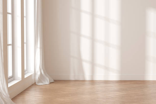 istock 3D rendering of white empty room with wooden floor and sun light cast shadow on the wall. 1330137745