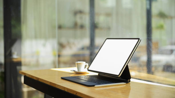 istock Portable tablet with keyboard in blank empty screen and copy space for product display on wooden table 1330141548