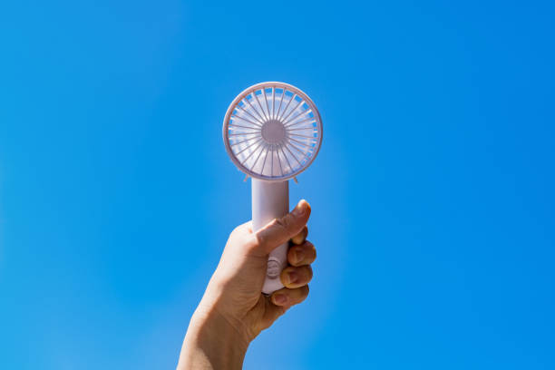 Portable handy fan in summer blue sky