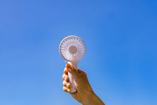 Portable handy fan in summer blue sky