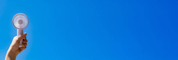 istock Portable handy fan in summer blue sky 1330143532