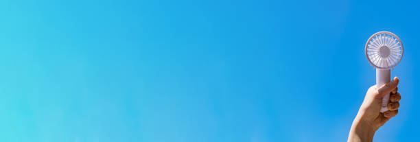 istock Portable handy fan in summer blue sky 1330143535