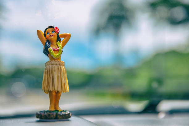 Hula doll on Hawaii car road trip travel vacation Hula dancer doll on Hawaii car road trip travel vacation. Aloha mini girl doll dancing on the dashboard in tropical nature landscape. Tourism and Hawaiian holiday freedom concept. hula dancer stock pictures, royalty-free photos & images