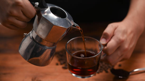 istock Barista pouring coffee from moka pot into a cup. 1330147895
