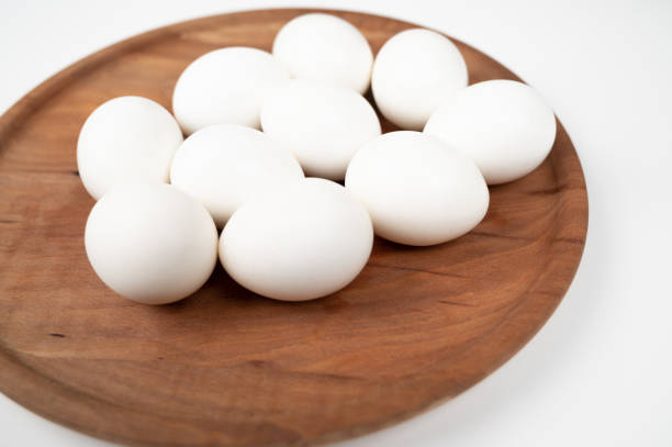 istock White eggs in a wooden plate isolated on a white background. Organic eggs. 1330157496