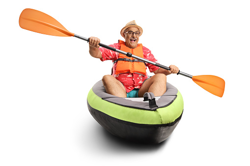 Mature man paddling in a kayak isolated on white background