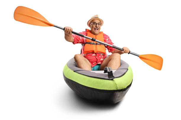 Mature man paddling in a kayak Mature man paddling in a kayak isolated on white background kayaking photos stock pictures, royalty-free photos & images