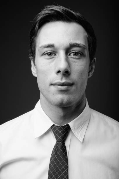 istock Young handsome businessman in black and white 1330157647