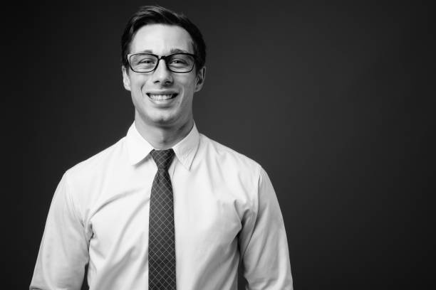 istock Young handsome businessman with eyeglasses in black and white 1330158155