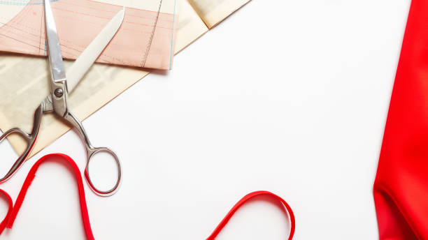 istock Sewing concept. Desk of seamstress. Textile, threads and scissors on white background top view copyspace 1330160594