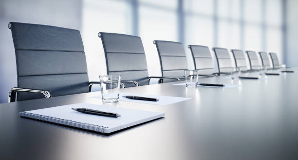 Meeting room in the office Close up of a large conference table with chairs in a meeting room in the high-rise office building, view of the skyline conference table stock pictures, royalty-free photos & images