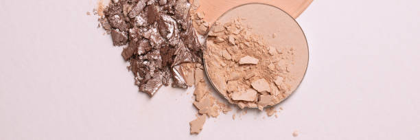istock Crashed beige face finishing and liquid powder and crashed eyeshadow texture. Macro texture of make-up on beige background 1330161665