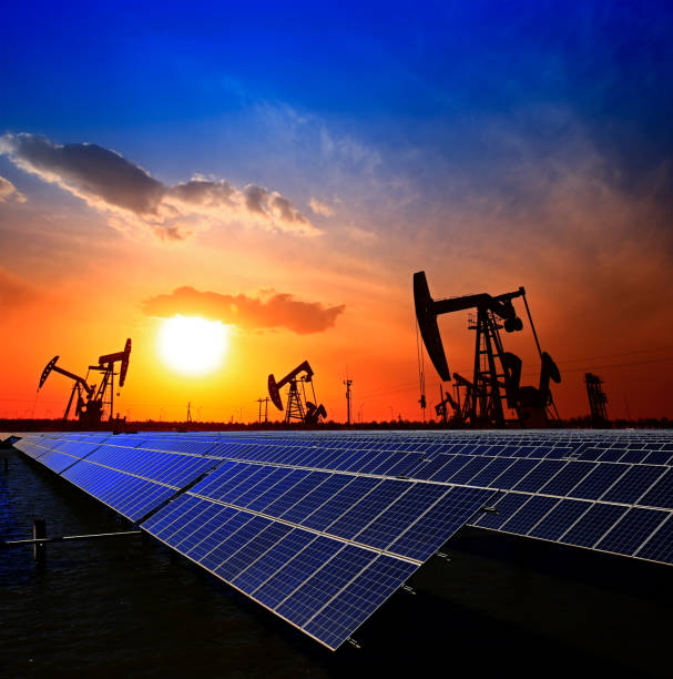 Oil pump with solar panels and the sunset Clean power energy concept,Oil pump with solar panels and the sunset power equipment stock pictures, royalty-free photos & images
