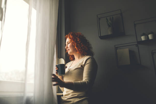 istock Looking outside, through the window, contemplating and enjoying coffee 1330162564