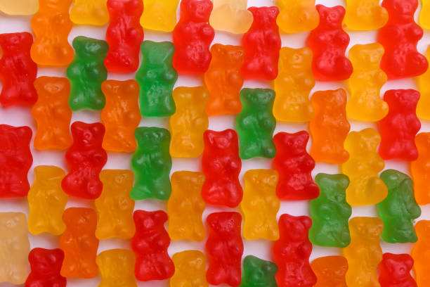 istock Many delicious little jelly bears on white background, flat lay 1330162669