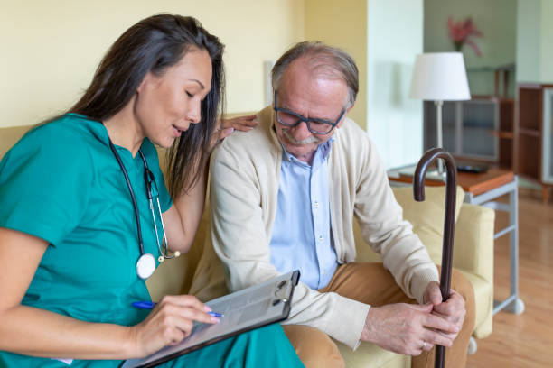 istock Sick Old Man is Receiving Advice From Nurse in Home Visit. 1330165957