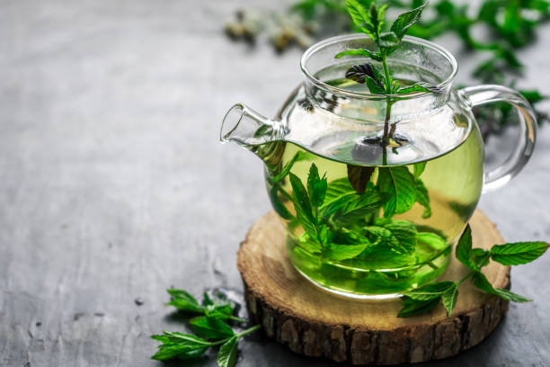 Herbal tea in a glass teapot on a rustic table Drink, hot, herbal medicine, green, close up, copy space, tea break herbal tea stock pictures, royalty-free photos & images