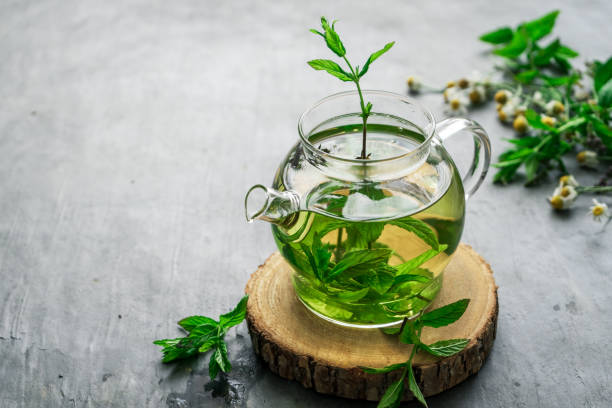 istock Herbal tea in a glass teapot on a rustic table 1330166865