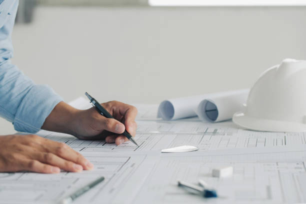 istock Close-up Of Engineer Hand Drawing Plan On Blue Print with architect equipment,architectural plan, sketching a construction project ,teamwork, and workflow construction concept 1330166905